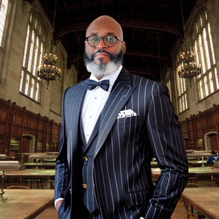 Carl Shawn Watkins standing in a grand library hall